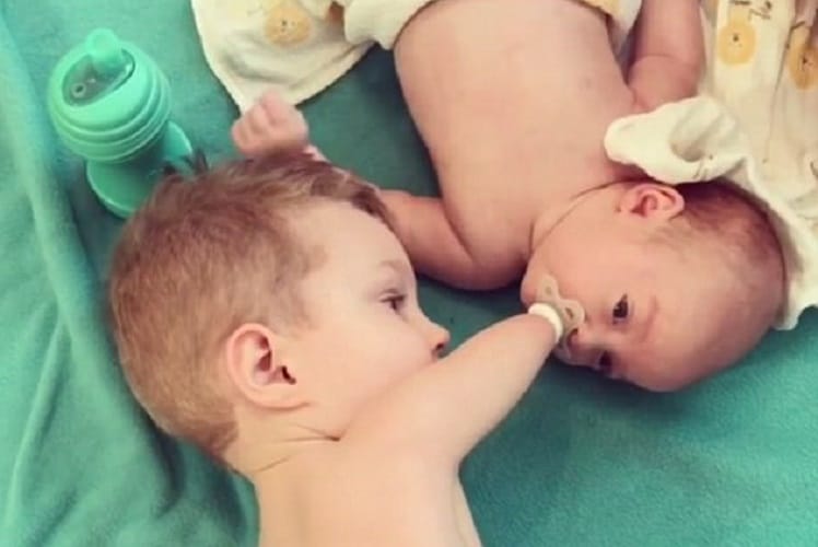  Camden born without hands or legs calms his baby brother crying by giving him a pacifier