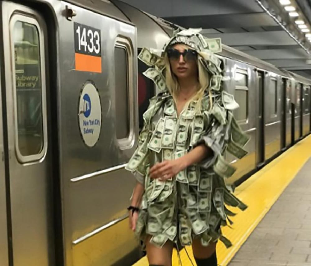 Women wears special dress made of notes asked people to take money in New York Metro
