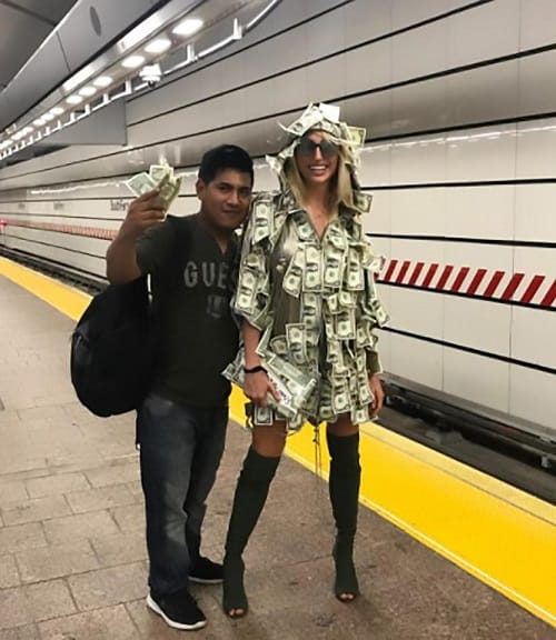 Women wears special dress made of notes asked people to take money in New York Metro