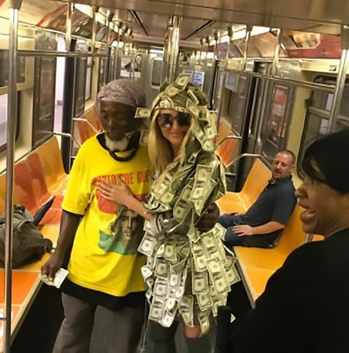 Women wears special dress made of notes asked people to take money in New York Metro