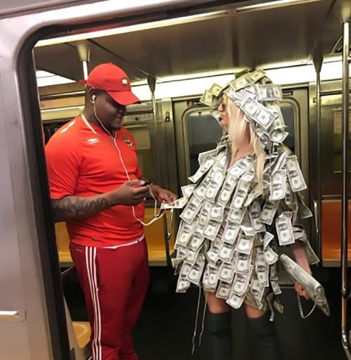 Women wears special dress made of notes asked people to take money in New York Metro