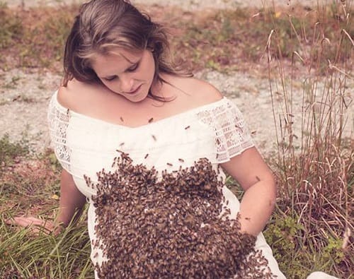 Pregnant mother weird maternity photo shoot with honey bees