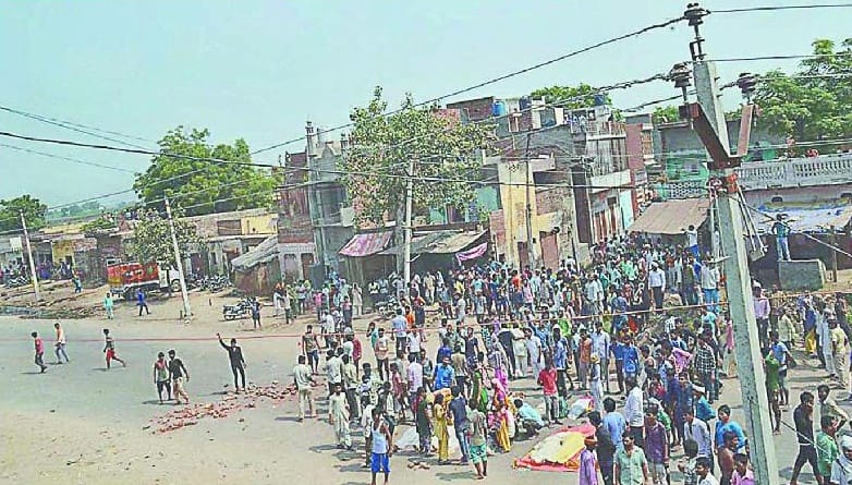 By reprimanding the lathis, kathha burn