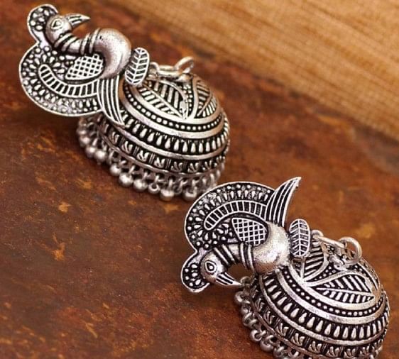 The trend of wearing ethnic earrings on western dress comes over again 