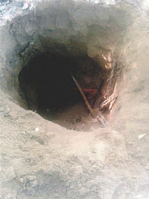 criminals cuts head from burried body