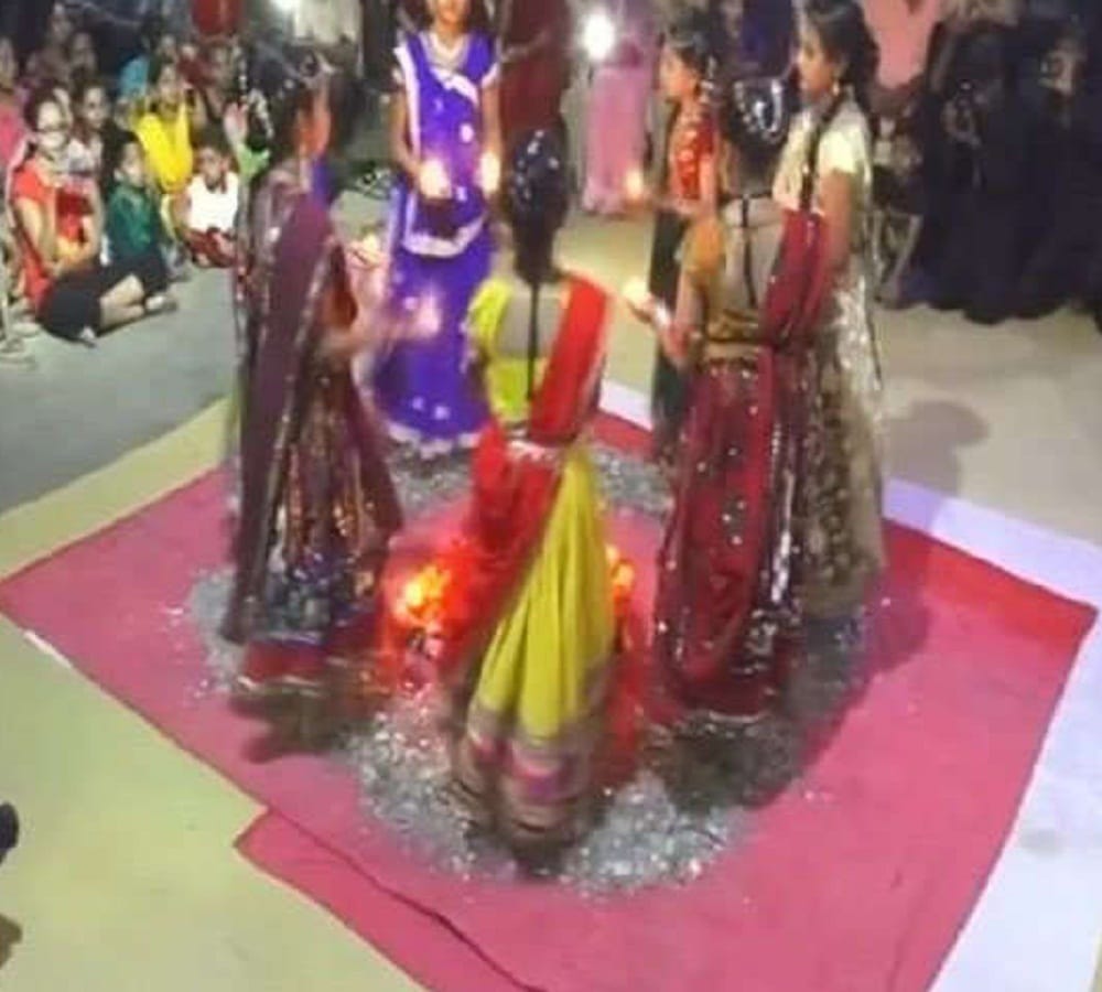 girls playing Garba on the pieces of glass at Durga ashtami in Junagarh