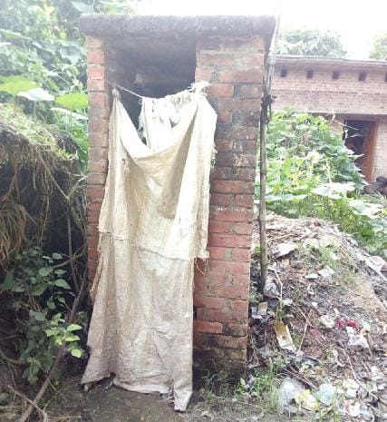 Sitting on a pile of dirt, open defecation villages claim