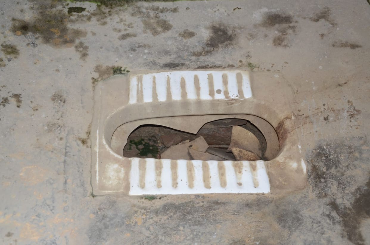 minor girl clean toilet in varanasi