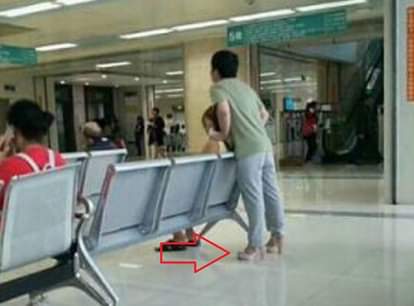 In china a man wear high heels to relieve her girlfriend tired feet