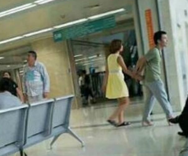 In china a man wear high heels to relieve her girlfriend tired feet