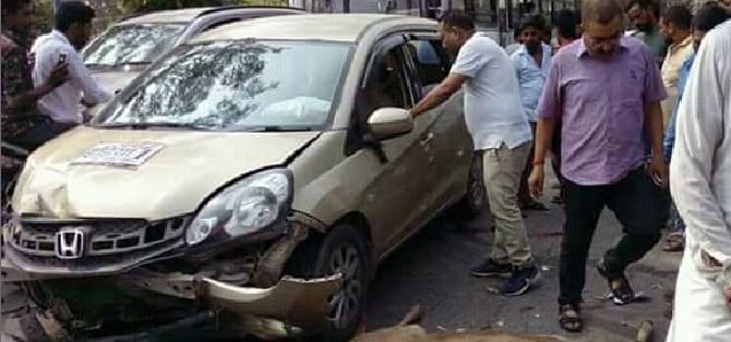 Bike rider collided with a car and hit the road