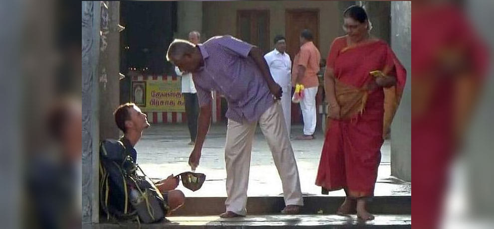 Russian tourist sat at the entrance of Sri Kumarakottam temple in Kancheepuram after his atm blocked