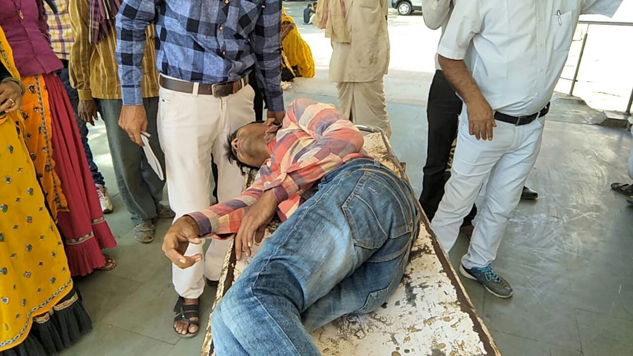 diwali door falls on bike rider in alwar market, Helmet saved his life