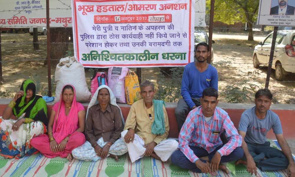 family protesting outside mathura dm office