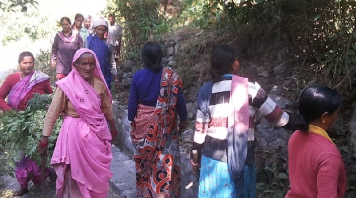 Villagers clean the canal