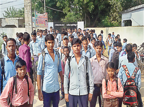 Students standing outside the gate closed