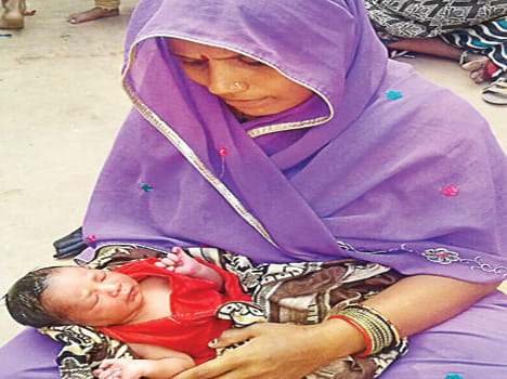 Newborn girl near the drain, mother took Yoda lap