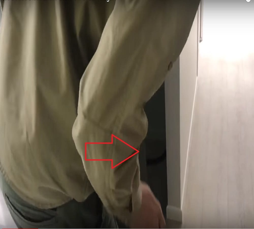 five feet snake crawling under a fridge inside a house