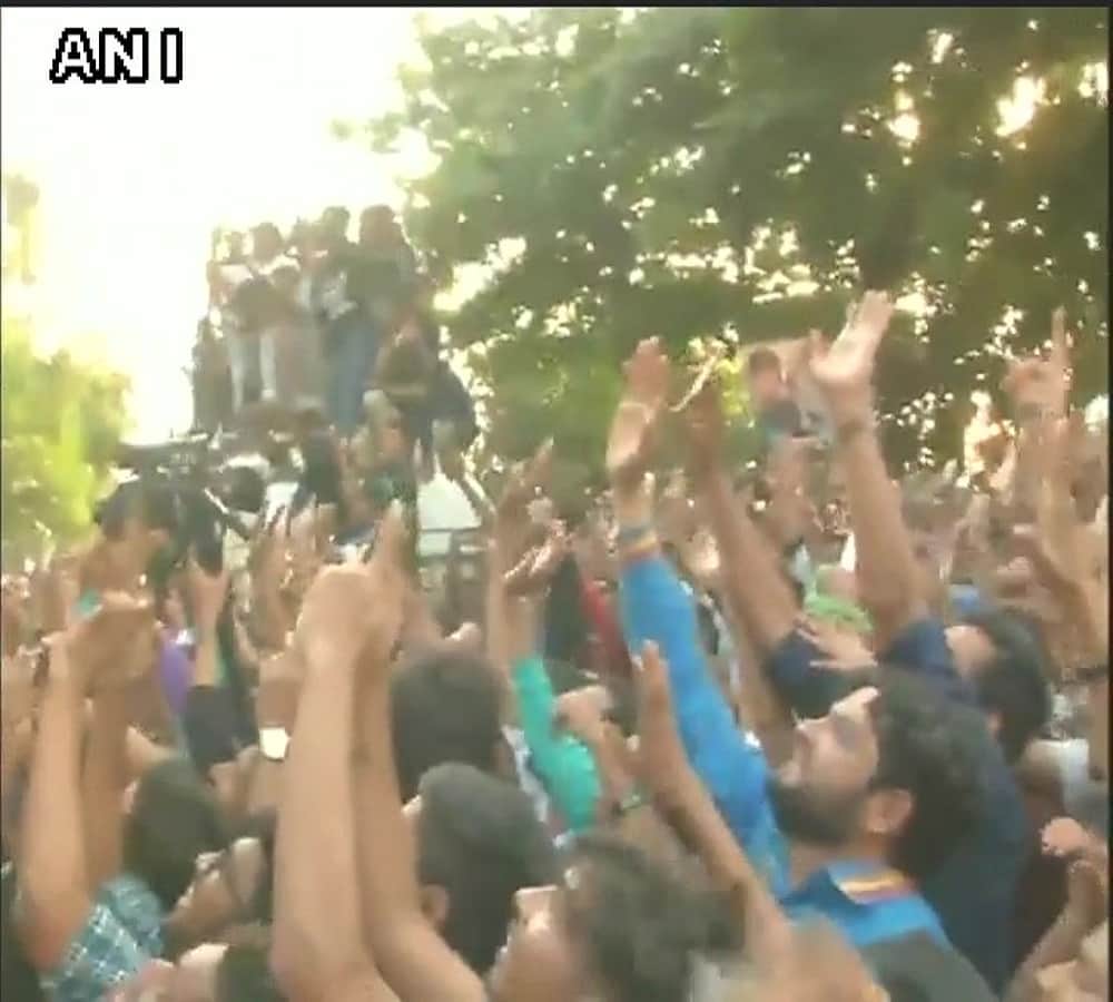 Actor Shah Rukh Khan greets his fans who had gathered outside his house 