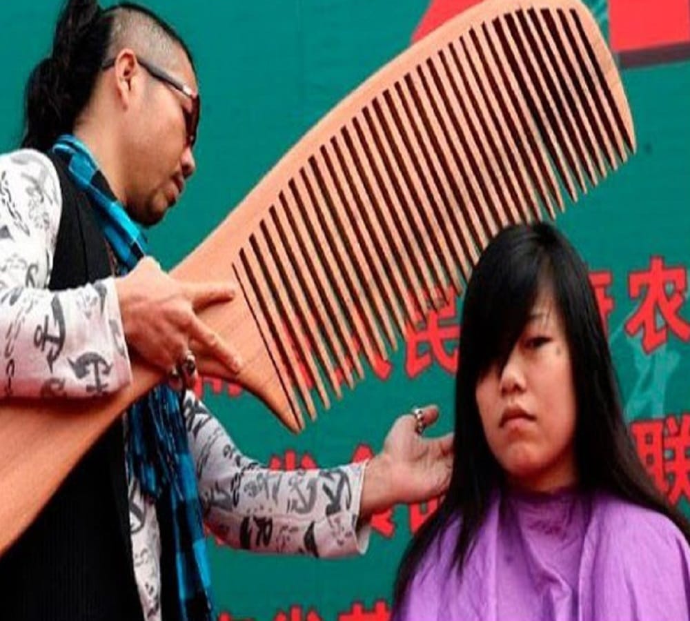 worlds largest comb and scissors used on this girl for hair cut