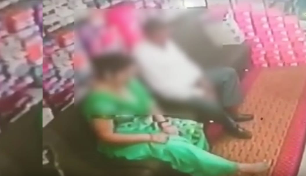 couple kissing scene captured at a footwear shop in CCTV