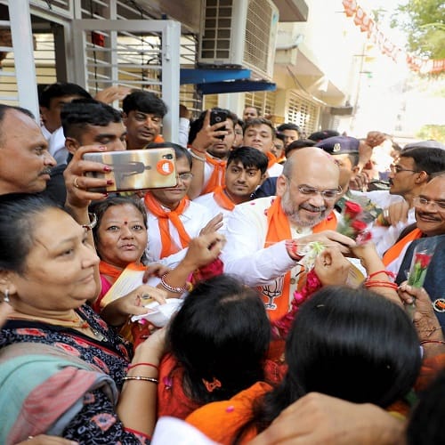 BJP President Amit Shah during his door-to-door campaign for Assembly polls, in Naranpura, Gujarat