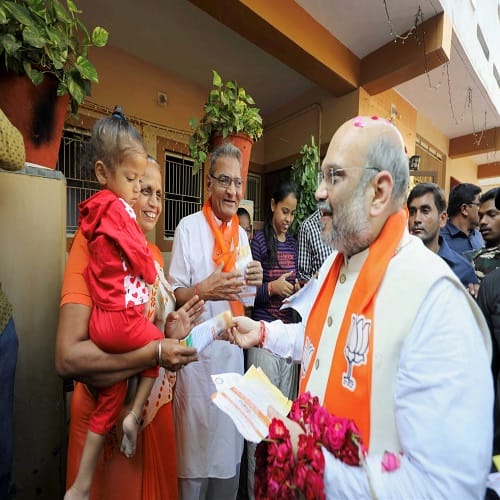BJP President Amit Shah during his door-to-door campaign for Assembly polls, in Naranpura, Gujarat