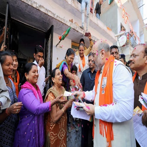 BJP President Amit Shah during his door-to-door campaign for Assembly polls, in Naranpura, Gujarat