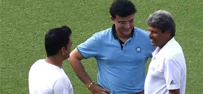 ms dhoni inspects eden gardens pitch while shooting with kapil dev