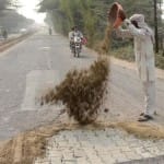तालानगरी में रामघाट रोड पर इंटरलॉकिंग ब्रिक्स को छिपाने के लिए मिट्टी डालता मजदूर।               