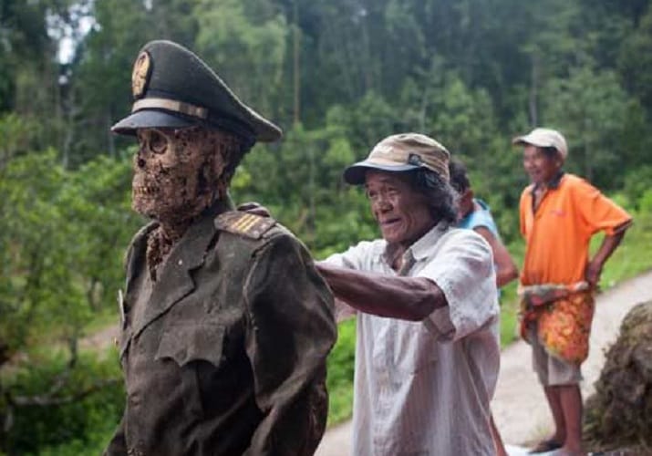 Toraja people in Indonesia honour their dead relatives by digging them up