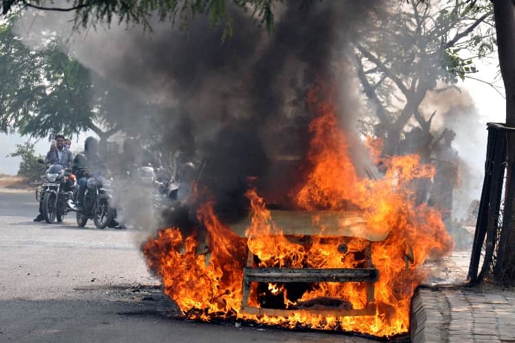 burning car on the road in lucknow 