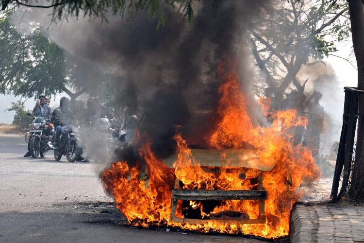 burning car on the road in lucknow 