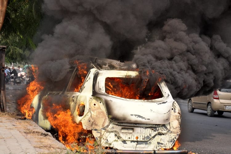 burning car on the road in lucknow 