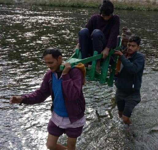 Villagers cross the Kosi river by sitting in the dolly