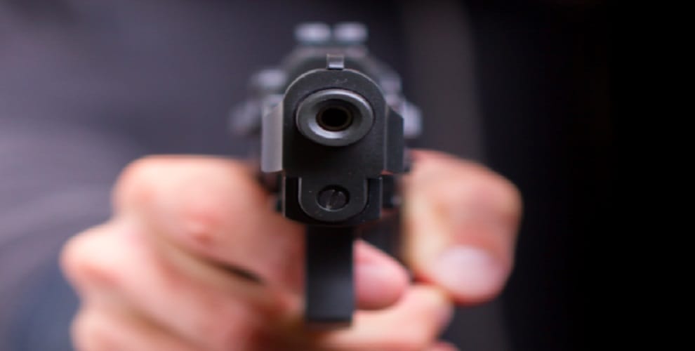 The policeman's gun point on the toll worker