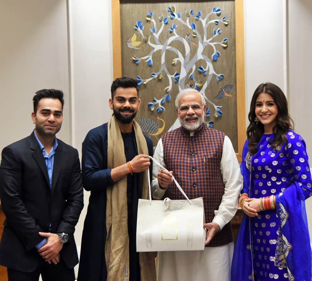 anushka sharma and virat kohli met pm modi and give invitation card