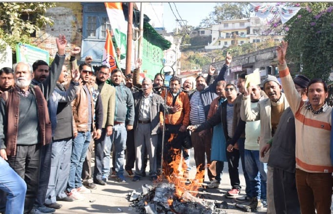 Congress workers blow the effigy 