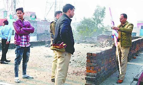 VHP activist spreads over religious flag on the overhead tank