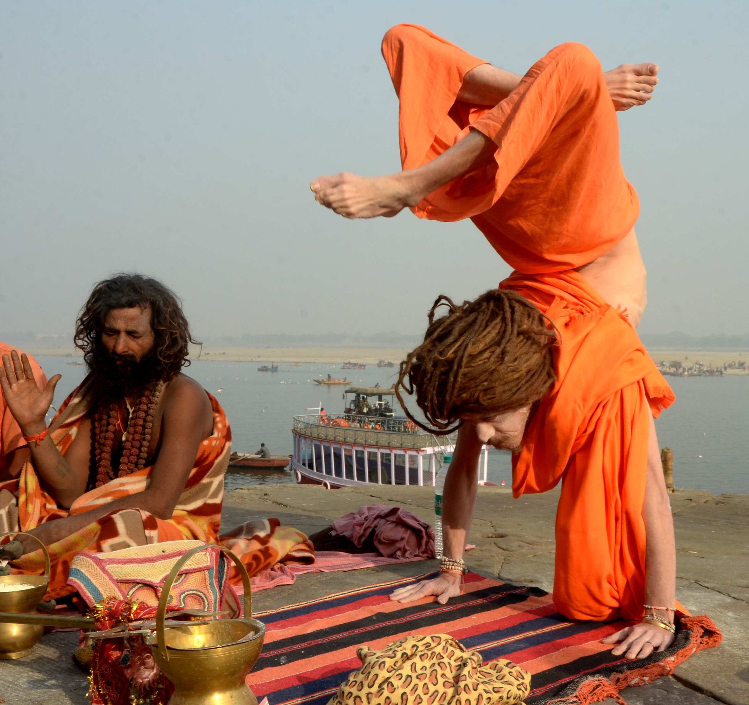 Foreign saint yoga on varanasi ganga ghat 