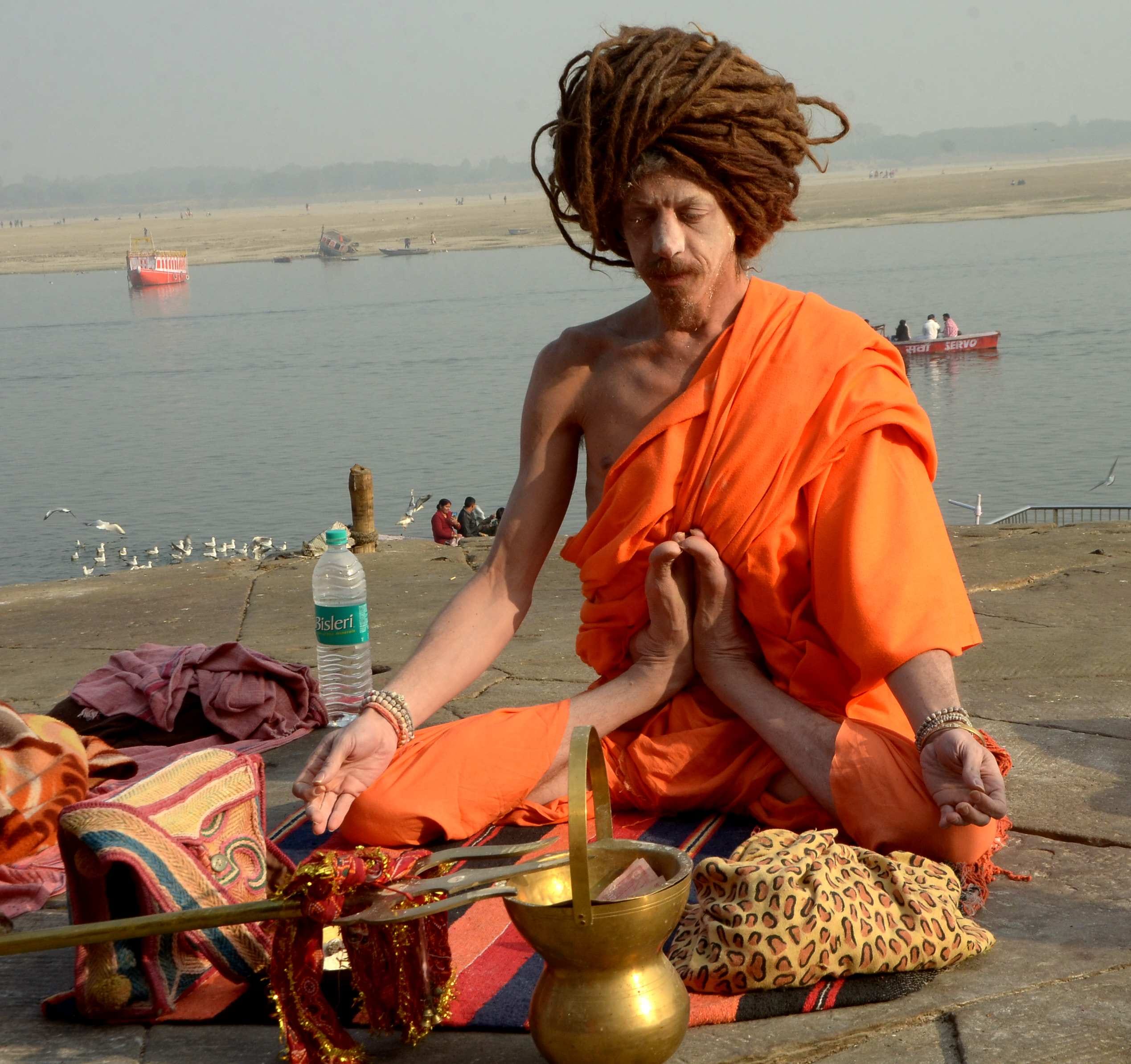 Foreign saint yoga on varanasi ganga ghat 