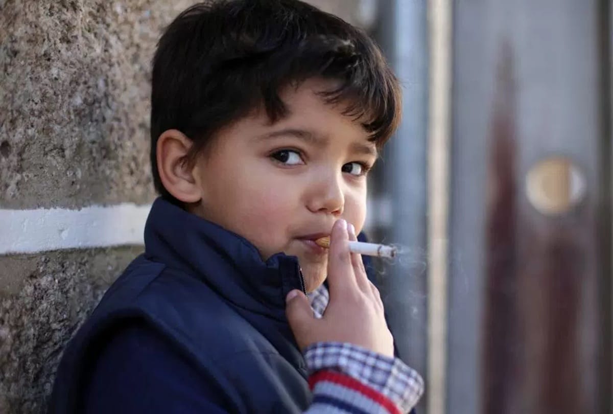 Children smoke cigarettes in this village celebrates traditional Epiphany 