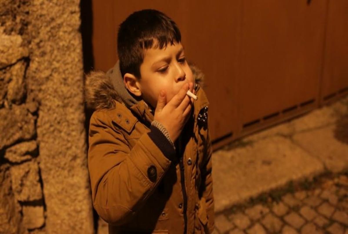 Children smoke cigarettes in this village celebrates traditional Epiphany 