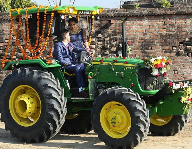 unique marriage in punjab, nri groom with bride arrives at reception on tractor