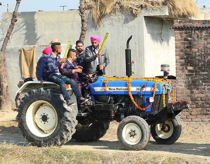unique marriage in punjab, nri groom with bride arrives at reception on tractor