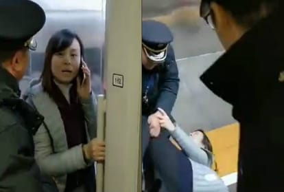 woman blocks door of high speed train for husband
