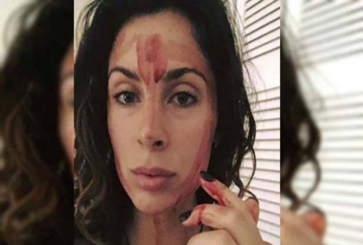 An Australian woman rub period blood on her face