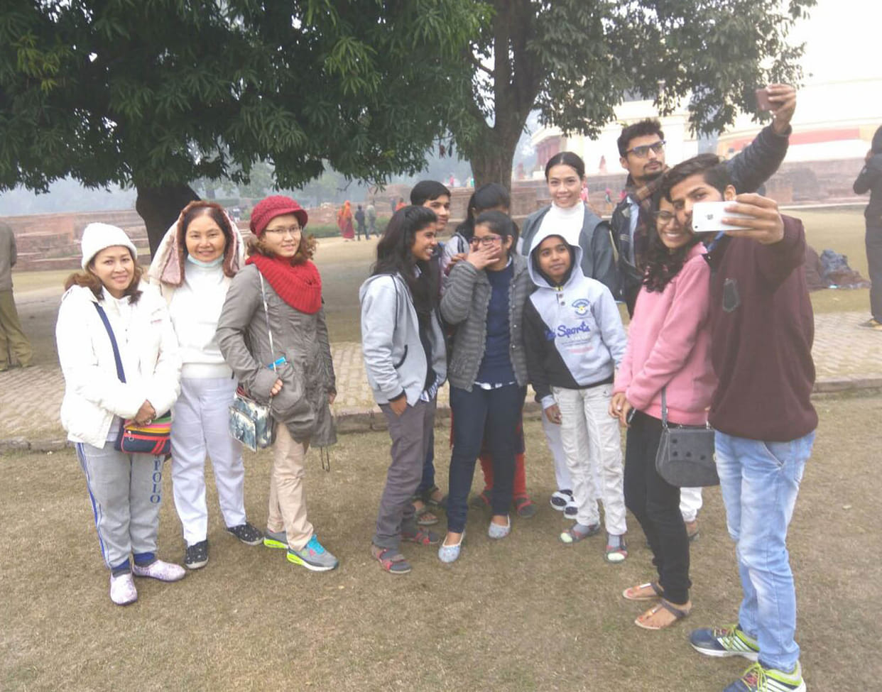 Exotic tourists enjoying selfie in the cold also