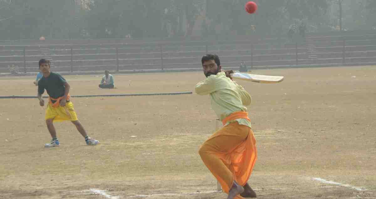 Student playing cricket match in dhoti kurta in varanasi
