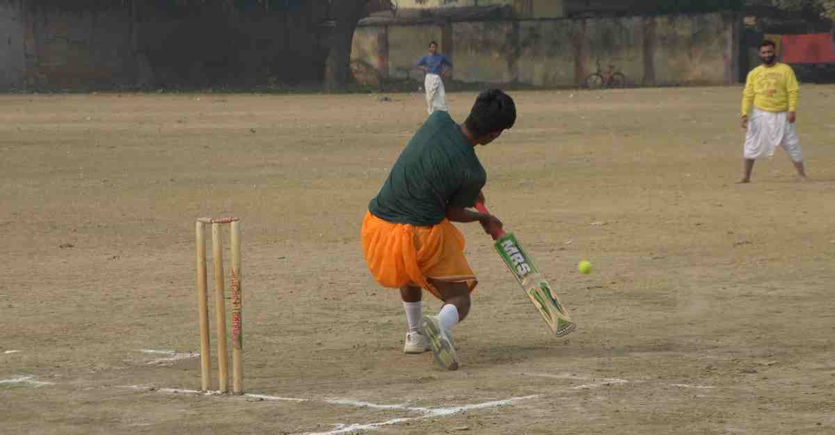 Student playing cricket match in dhoti kurta in varanasi